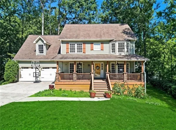 a front view of a house with a yard table and chairs