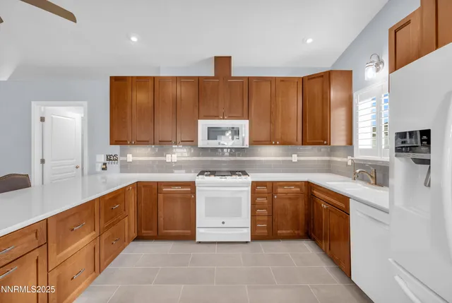 a kitchen with stainless steel appliances granite countertop a sink and dishwasher a stove top oven with wooden floor
