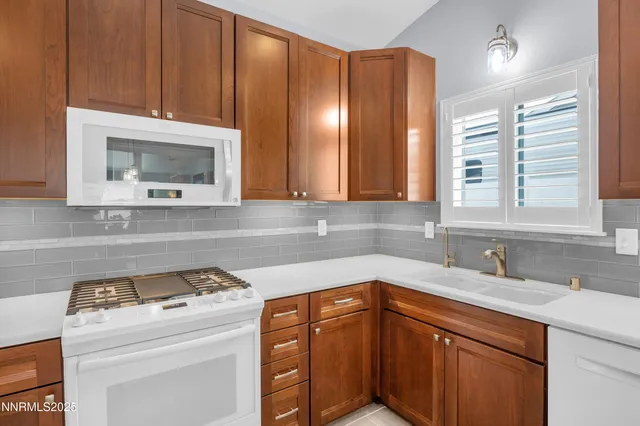 a kitchen with a sink cabinets and appliances