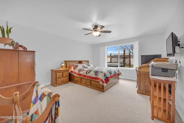 a bedroom with furniture and a flat screen tv