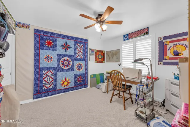 a workspace with furniture and ceiling fan