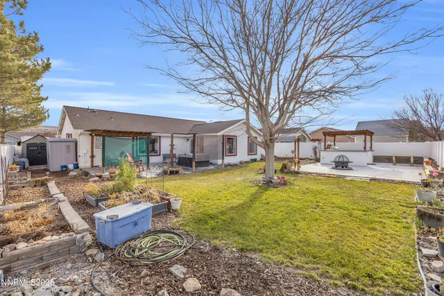 a front view of a house with swimming pool and furniture