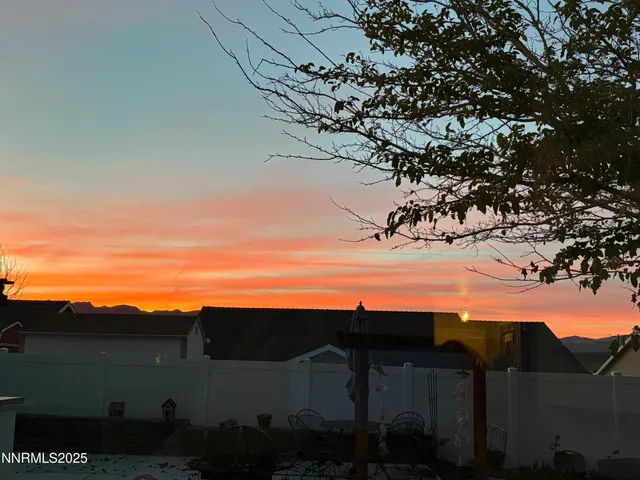 a view of a yard with an outdoor seating a tree
