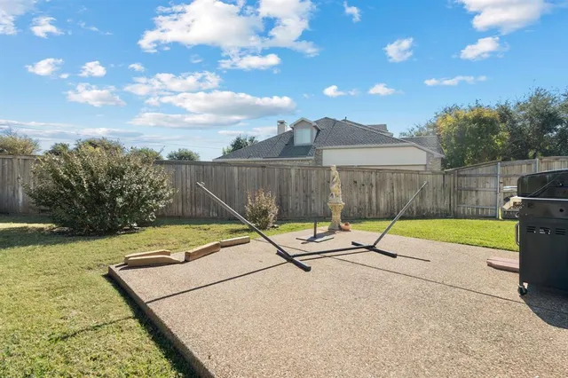 a view of a swimming pool with a patio and a yard
