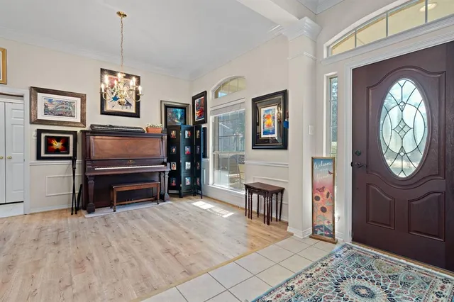 a living room with furniture a computer on desk and chair