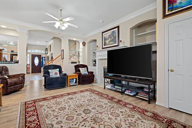 a living room with furniture and a flat screen tv