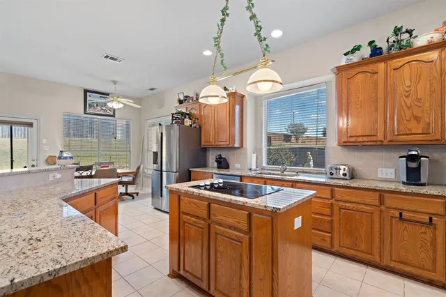 a kitchen with granite countertop a sink stove and cabinets