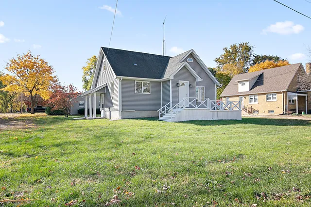 a front view of house with yard and trees
