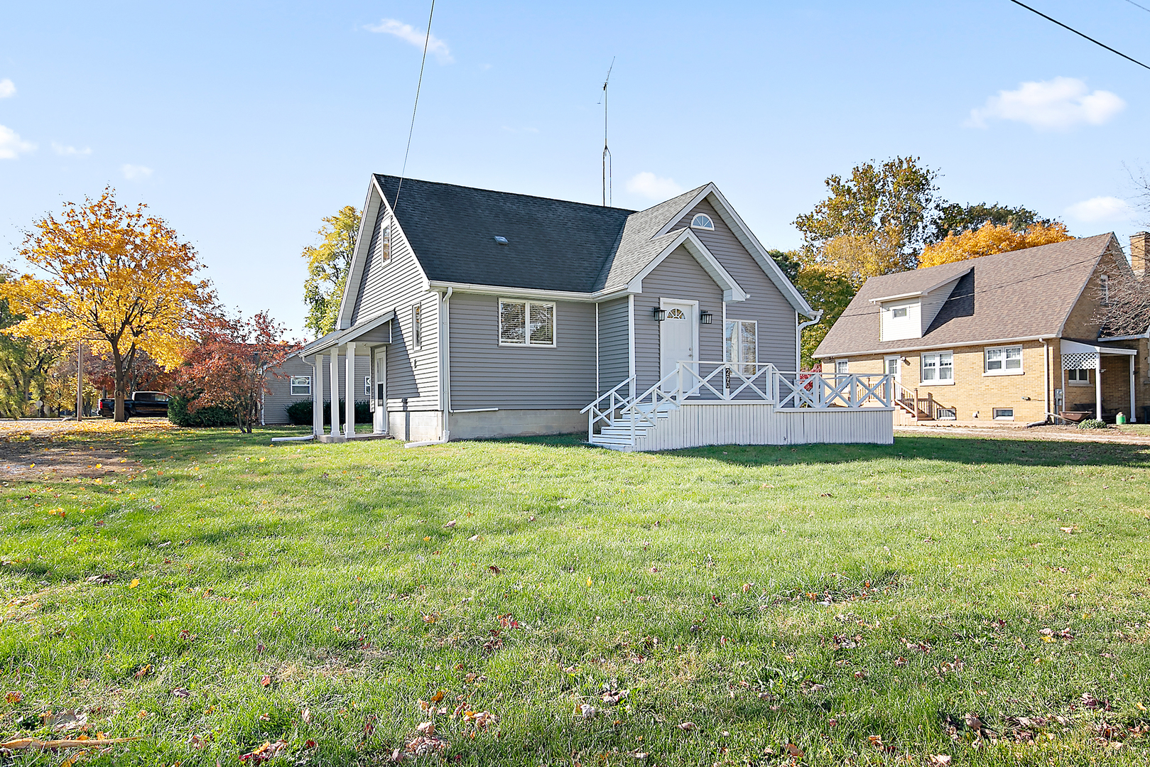 a front view of house with yard and trees