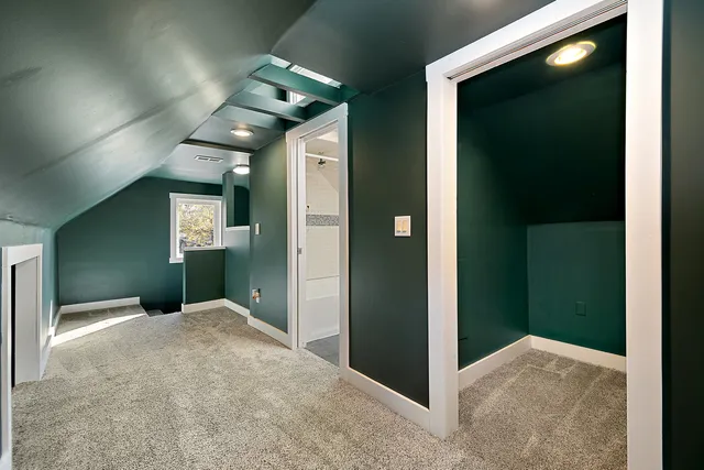a view of a hallway with a livingroom and a bathroom with sink