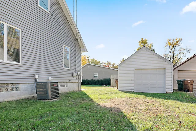 a view of a house with a yard and garage