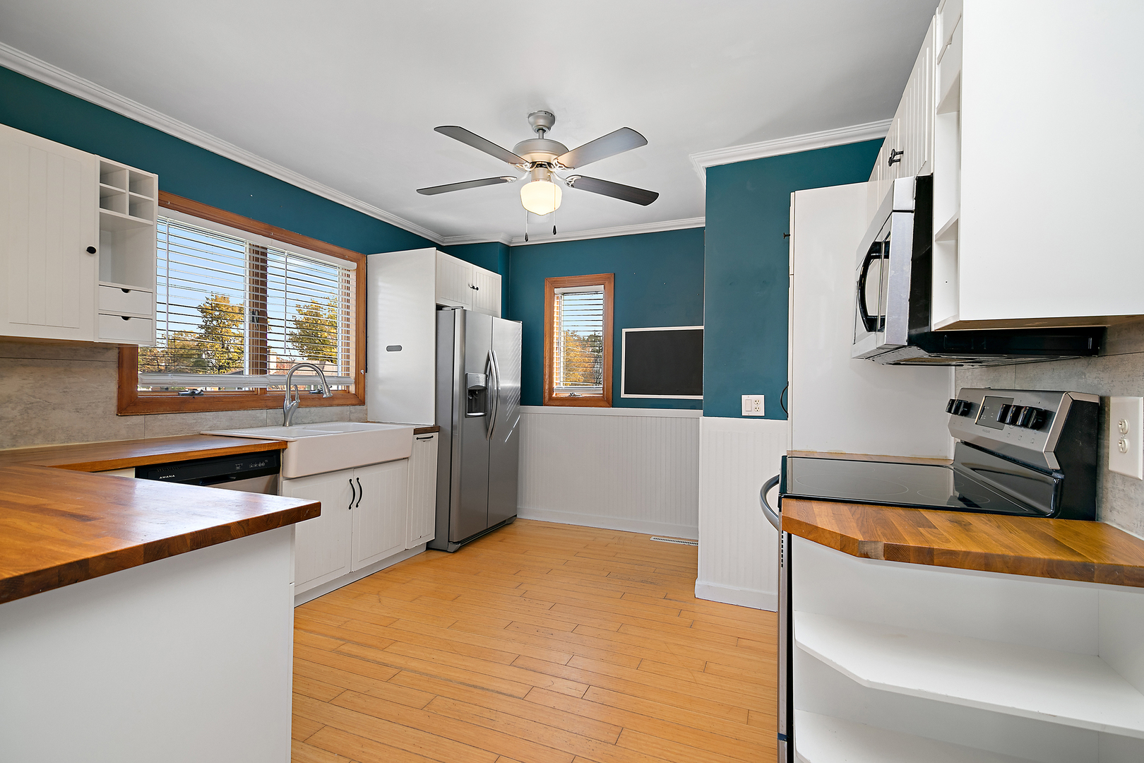 290 East 1st Avenue Clifton, IL 60927 - Photo 4 of 20 a kitchen with stainless steel appliances granite countertop a sink dishwasher a stove and a refrigerator with wooden floor