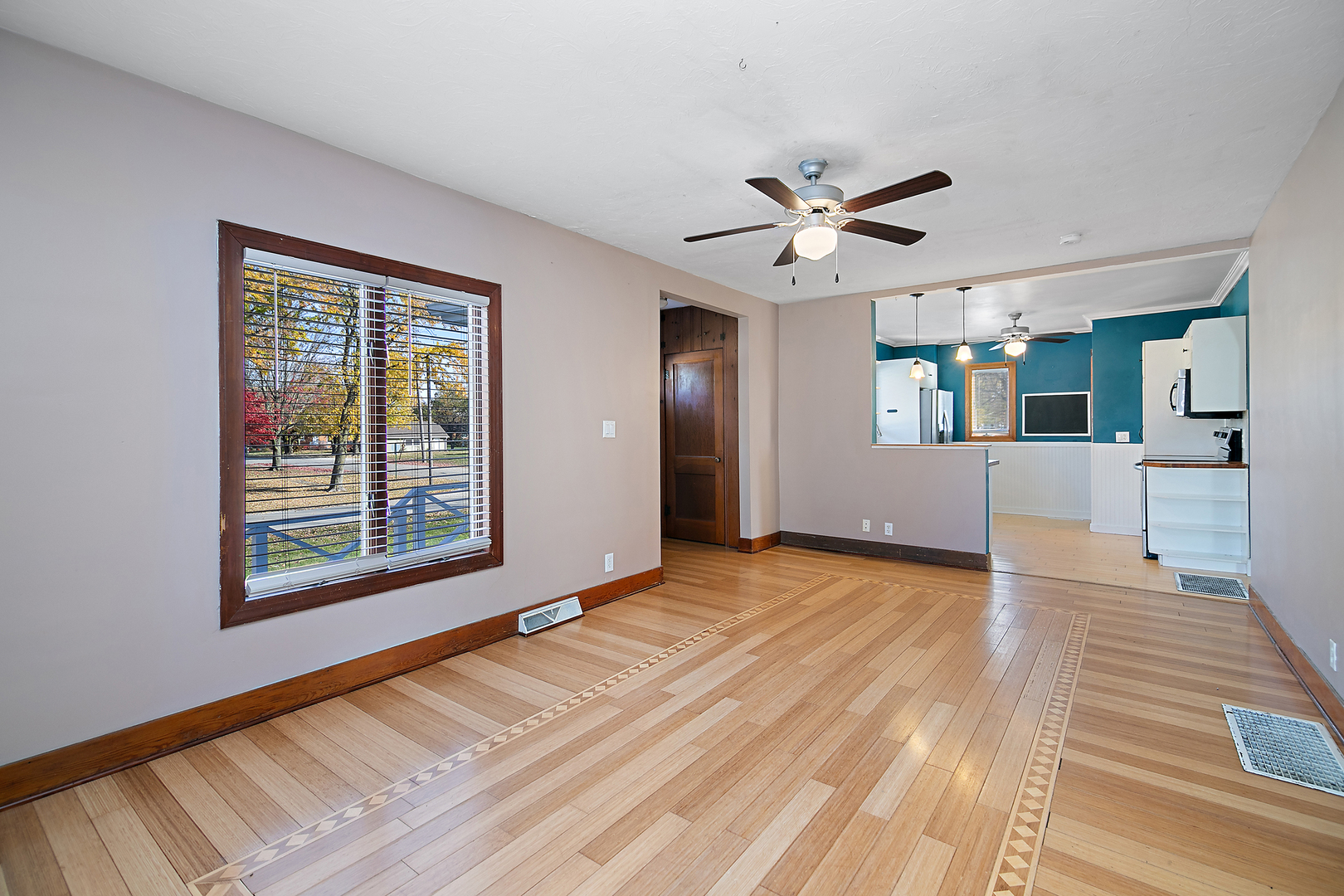 290 East 1st Avenue Clifton, IL 60927 - Photo 5 of 20 a view of an empty room with a window and wooden floor