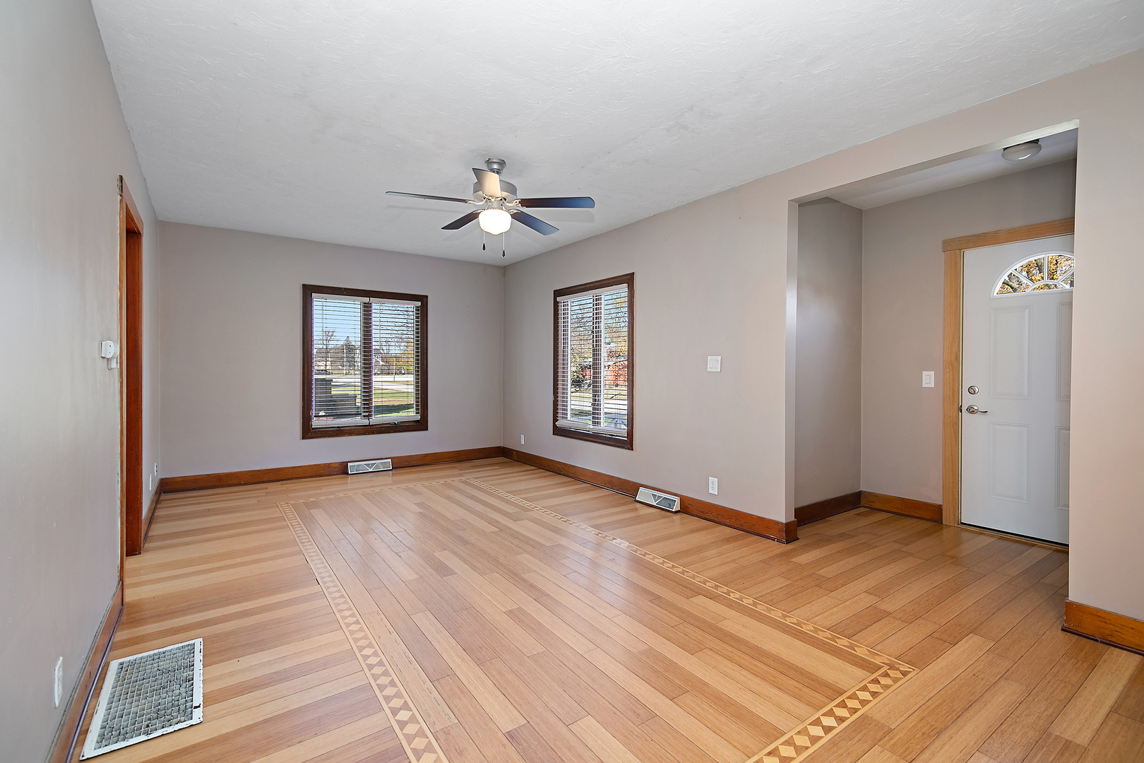 290 East 1st Avenue Clifton, IL 60927 - Photo 6 of 20 a view of an empty room with window and wooden floor