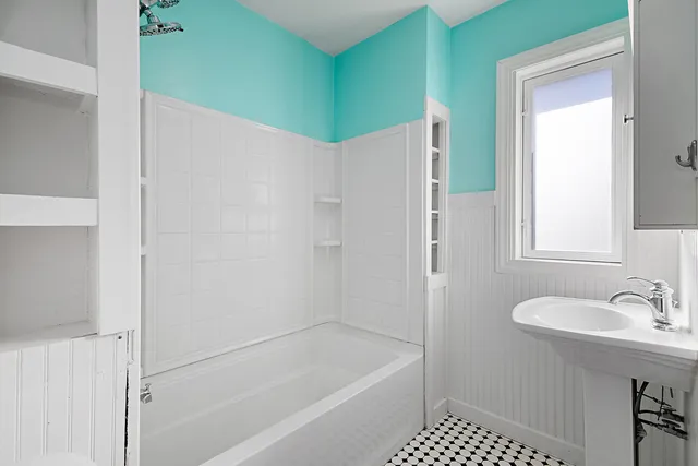 a bathroom with a shower and a sink