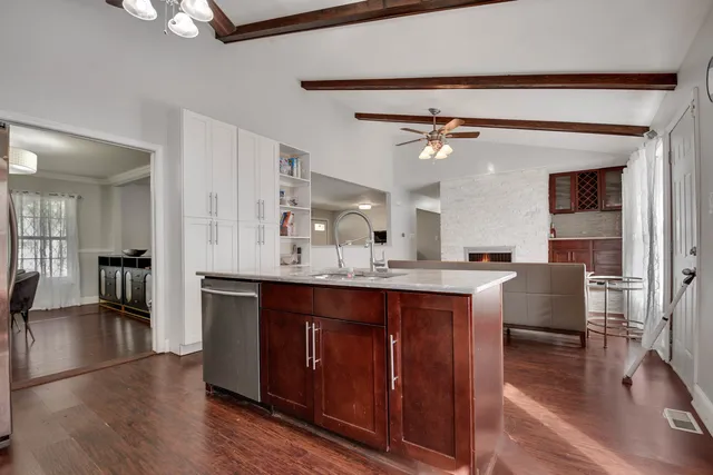a large kitchen with a table and chairs
