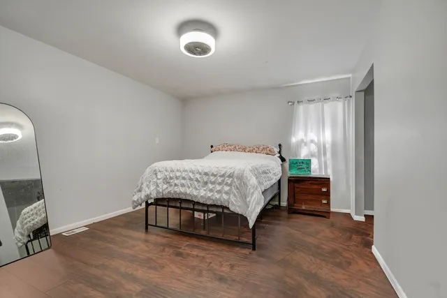 a bedroom with a bed and a table