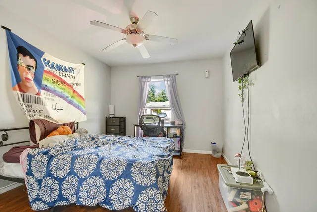 a bedroom with a bed and a chandelier