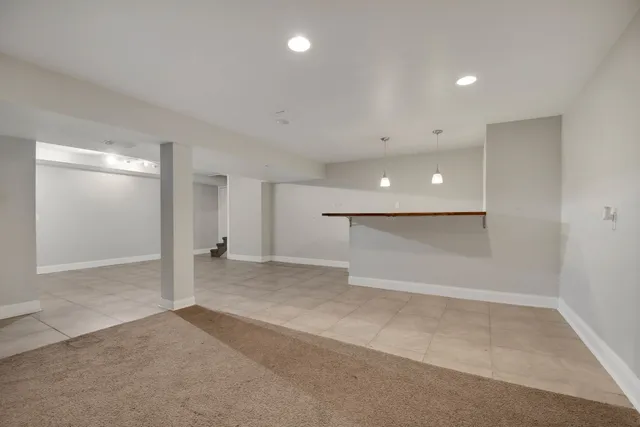 an empty room with a cabinet and mirrors