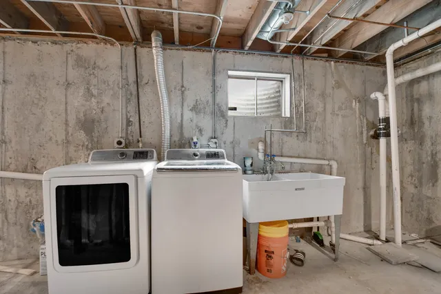 a view of a house with a yard and a tree