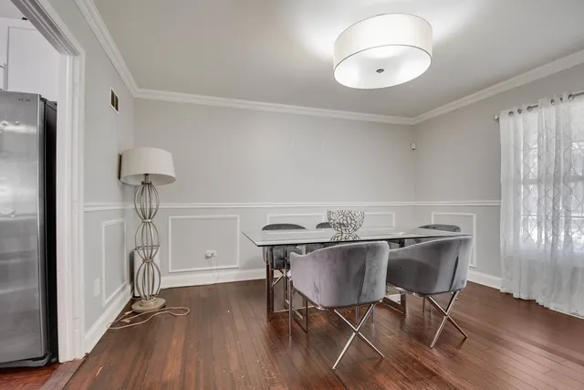 a view of a dining room with furniture wooden floor and chandelier