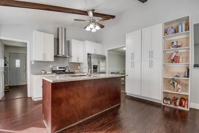 a view of kitchen with cabinets and wooden floor