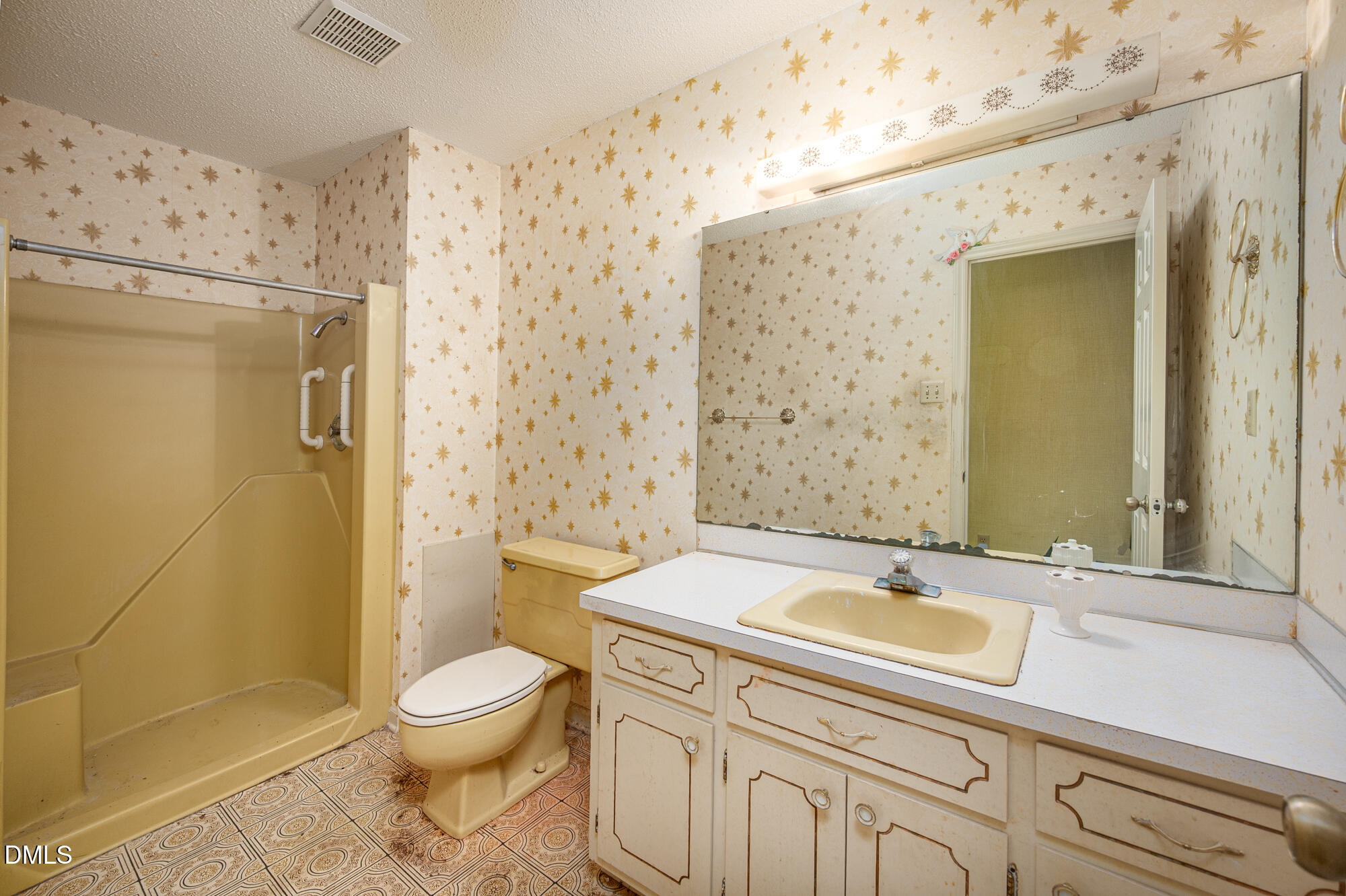 4411 Rhew Drive Durham, NC 27704 - Photo 22 of 34 a bathroom with a sink a toilet and shower