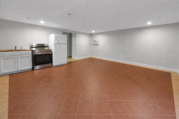 a view of a kitchen with a sink an oven and cabinets