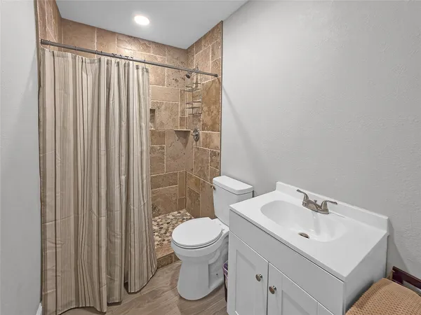 a bathroom with a toilet a sink and a shower