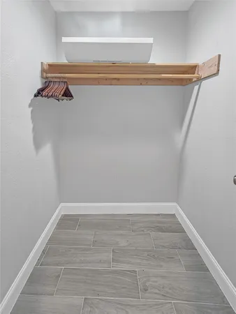 a view of walk in closet with clothes
