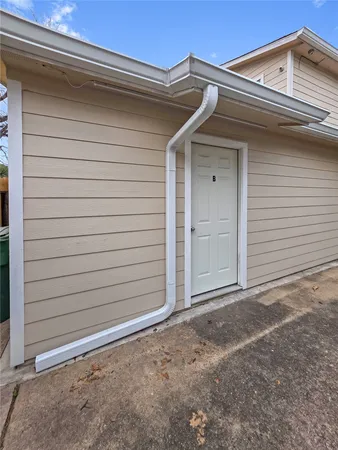 a view of front door and a yard