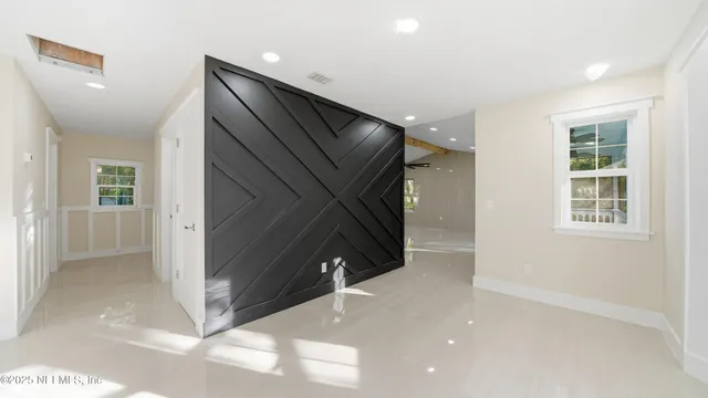 a kitchen with refrigerator and cabinets