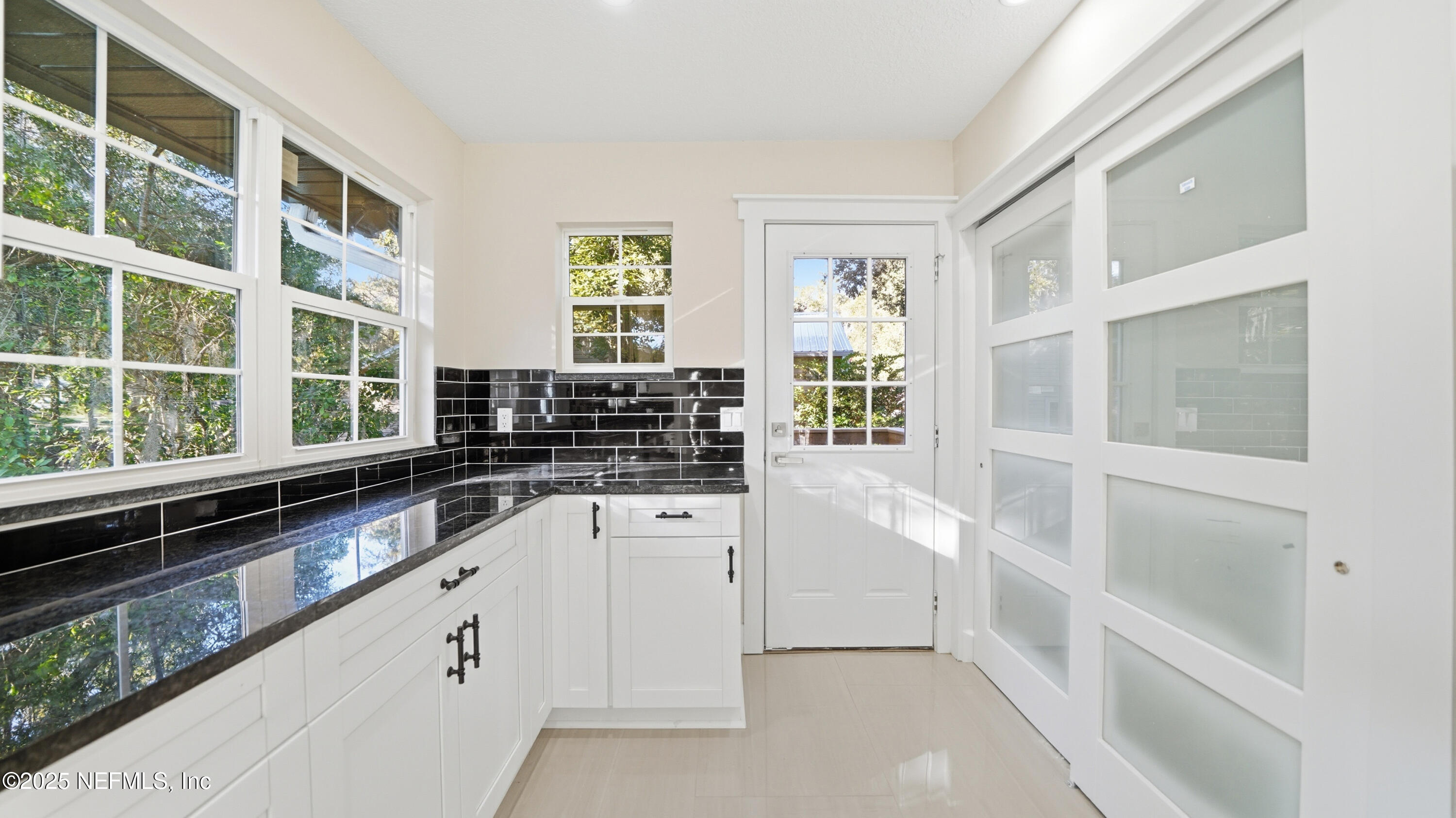 3217 Turtle Creek Road St. Augustine, FL 32086 - Photo 16 of 57 a kitchen with white cabinets and a window