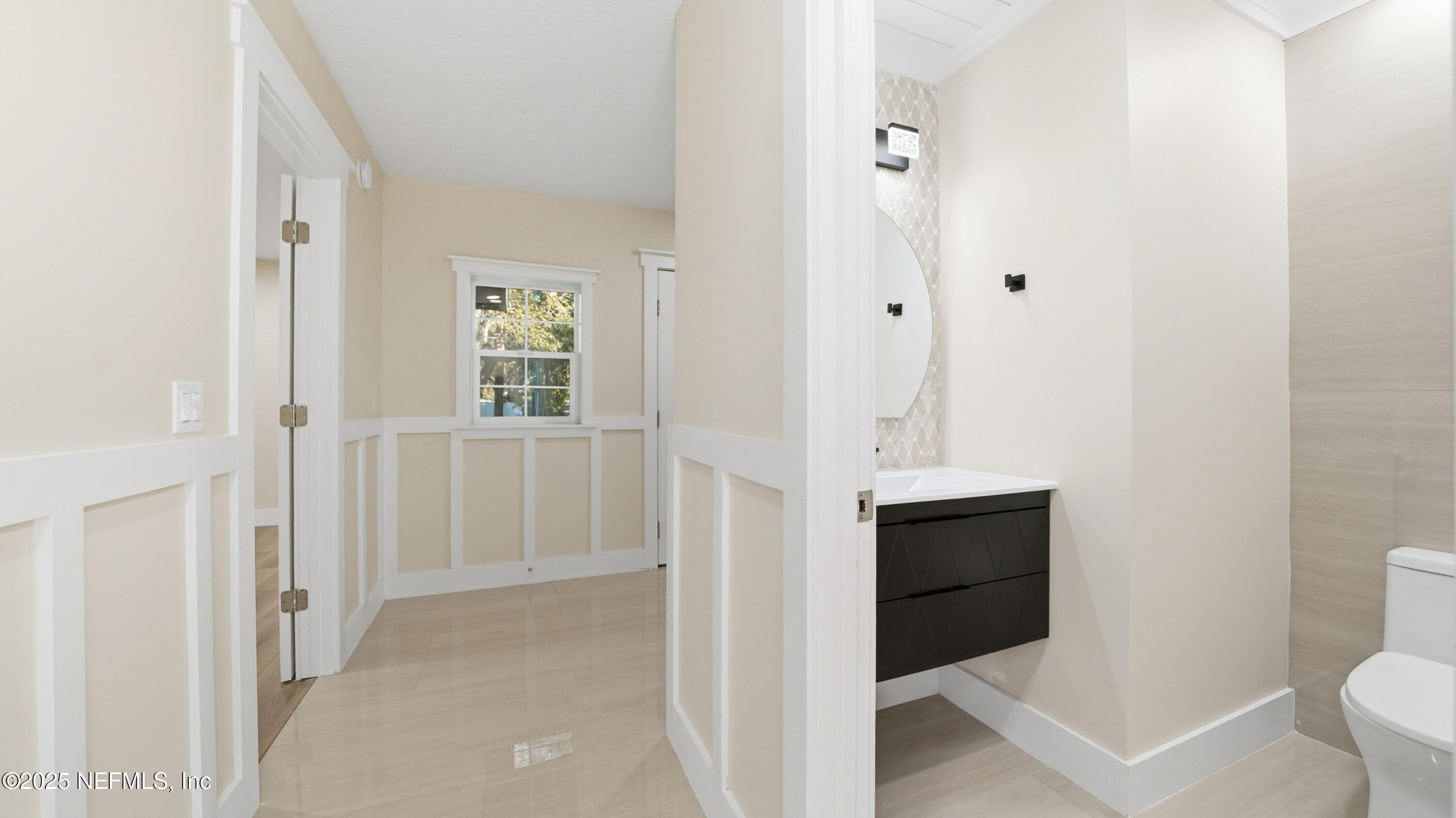 3217 Turtle Creek Road St. Augustine, FL 32086 - Photo 18 of 57 a bathroom with a toilet sink and mirror