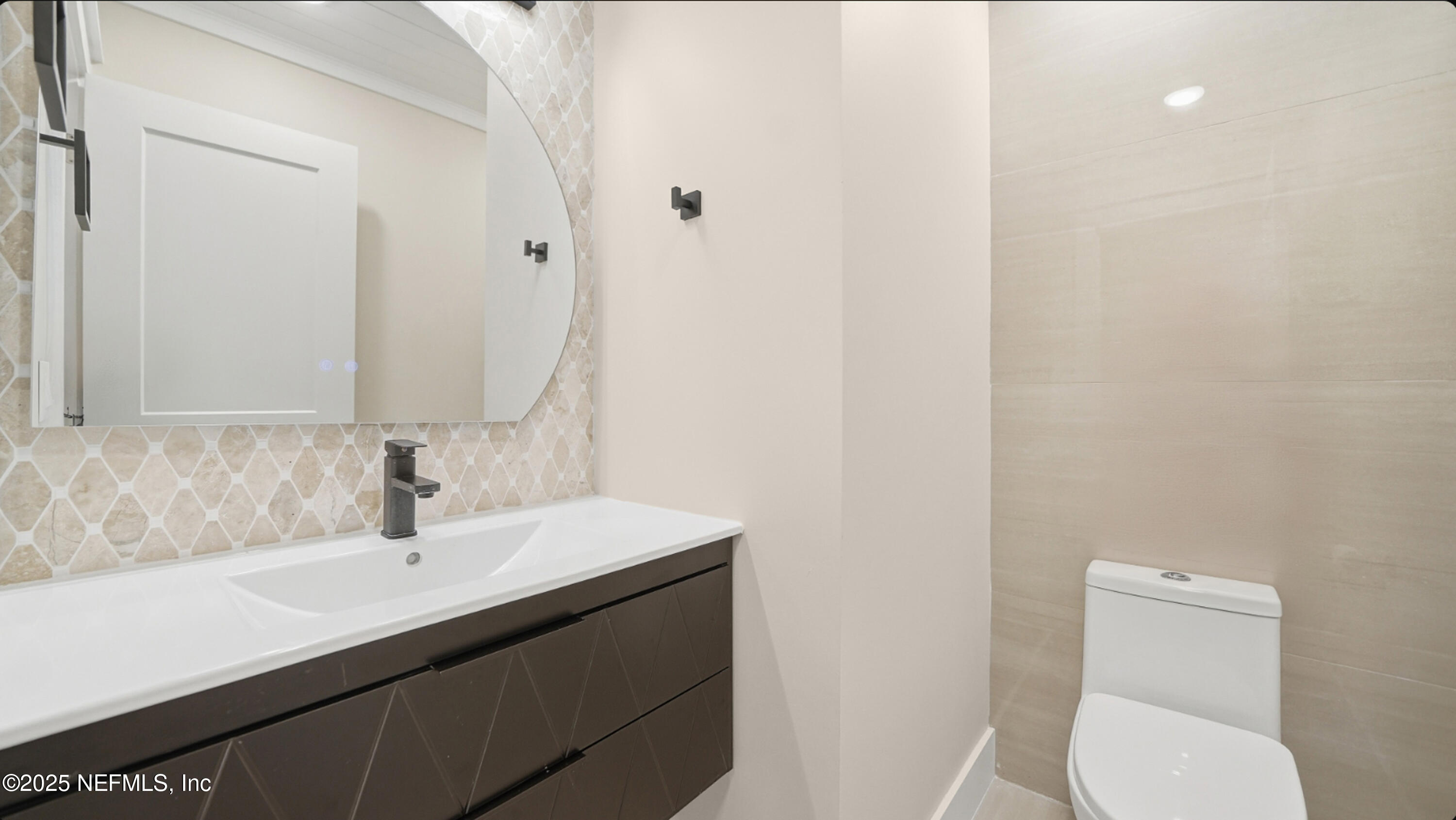 3217 Turtle Creek Road St. Augustine, FL 32086 - Photo 19 of 57 a bathroom with a sink a toilet and mirror