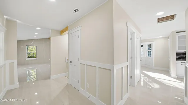 a view of a room with wooden floor