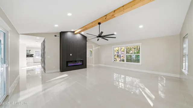 a view of a hallway with a window and a livingroom