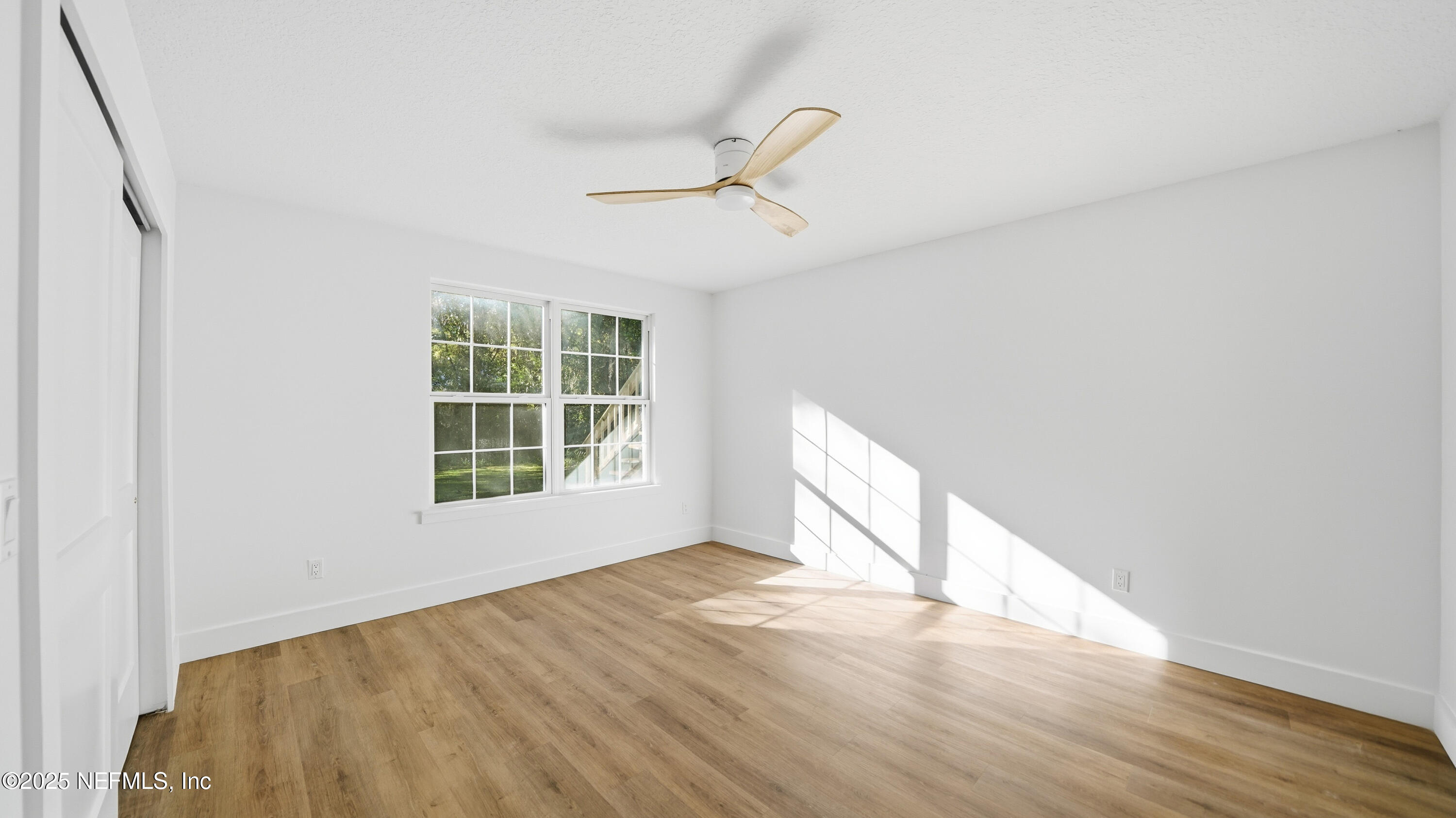 3217 Turtle Creek Road St. Augustine, FL 32086 - Photo 41 of 57 an empty room with wooden floor fan and windows