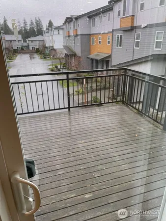 a view of a balcony with wooden floor