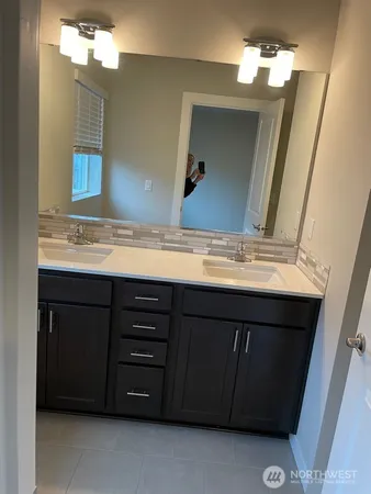 a bathroom with a sink vanity and mirror