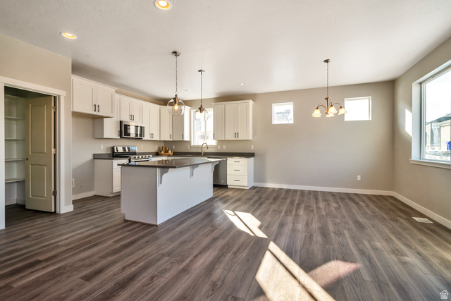 2449 Scarlet Road, Unit 249 Eagle Mountain, UT 84005 - Photo 17 of 26 Open-concept living area featuring wood-finish flooring and recessed lighting