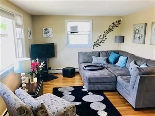 116 Upton Road Waltham, MA 02452 - Photo 6 of 15 a living room with furniture and a flat screen tv