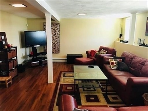 116 Upton Road Waltham, MA 02452 - Photo 10 of 15 a living room with furniture and a flat screen tv