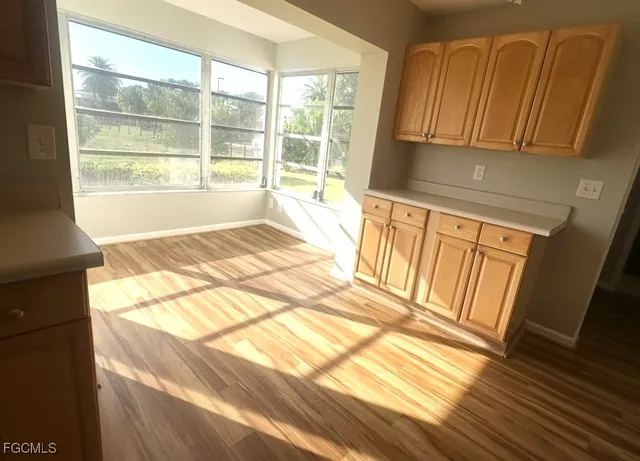 a view of a kitchen with wooden floor and a sink