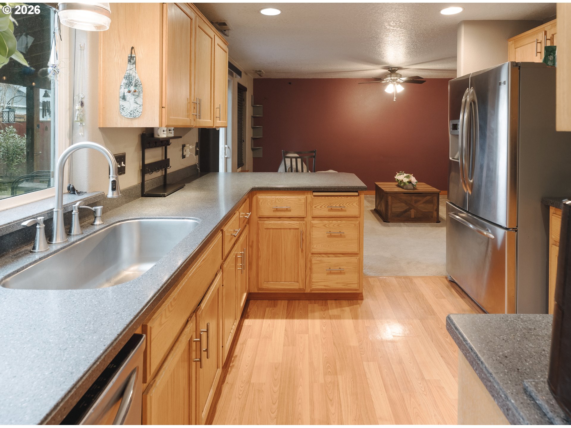 1254 Crystal Lane Lafayette, OR 97127 - Photo 2 of 34 a kitchen with kitchen island a counter top space a sink a refrigerator and a lots of counter space