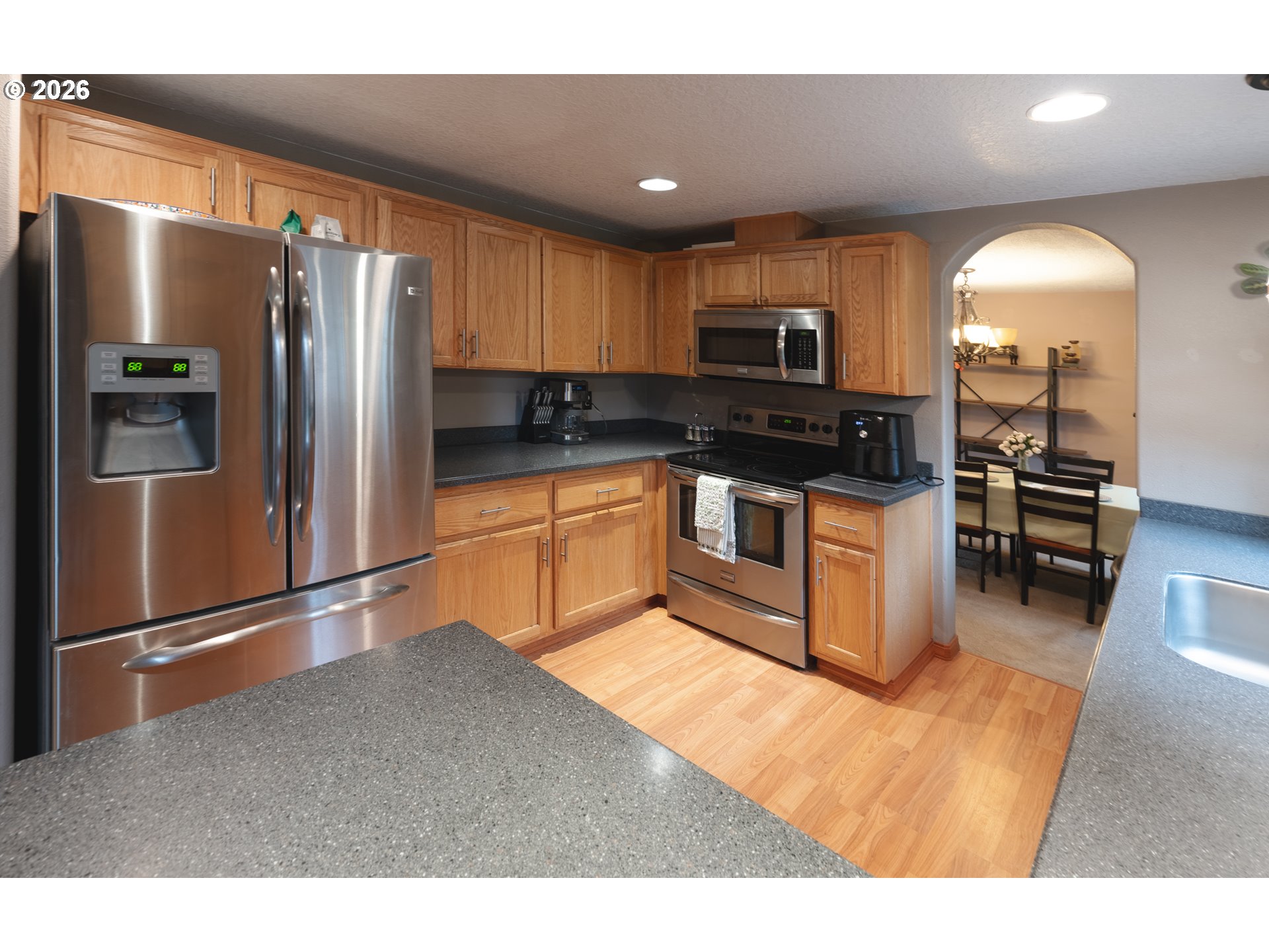 1254 Crystal Lane Lafayette, OR 97127 - Photo 4 of 34 a kitchen with stainless steel appliances granite countertop a refrigerator a stove a sink and a microwave