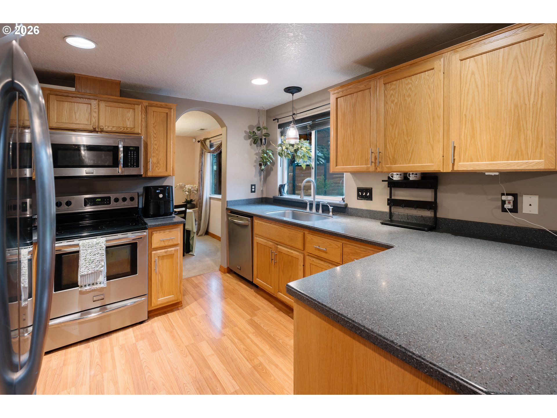 1254 Crystal Lane Lafayette, OR 97127 - Photo 6 of 34 a kitchen with stainless steel appliances a sink a stove and microwave