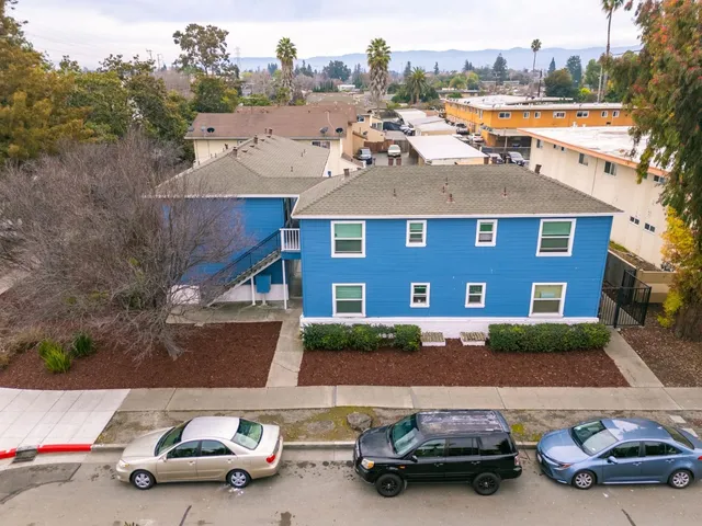 an aerial view of a house with car parked