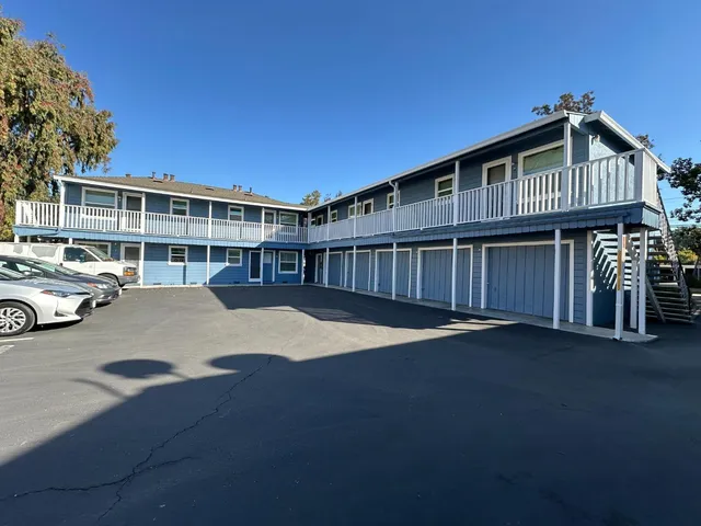 a kitchen with a sink stove top oven and cabinets