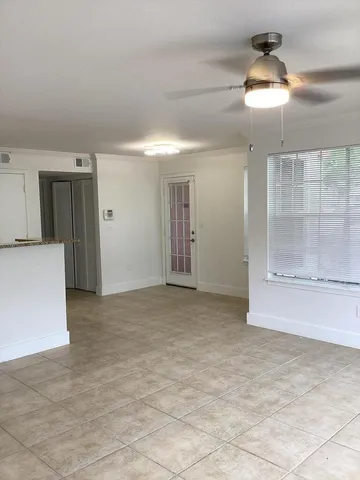 a view of a kitchen with granite countertop a sink and a stove top oven